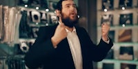 a man in a suit with a beard in a store